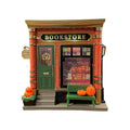 Small white cartoon house night lamp ornament with red roof on wooden surface.