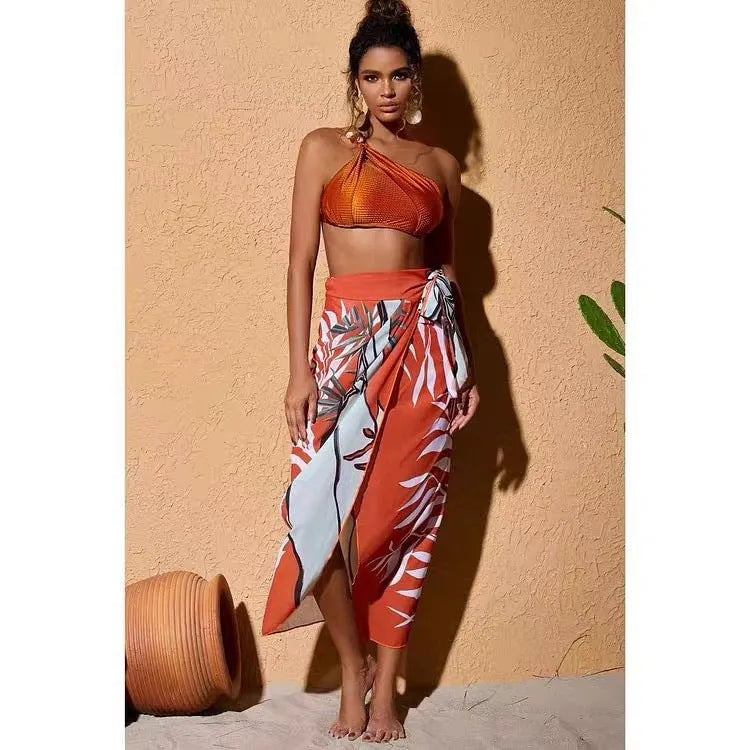 Women's brown push up bikini with high waist briefs and matching chiffon dress cover-up laid flat.