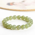 Polished Hetian jade ball bracelet showing spherical beads on a wrist, available in deep or shallow ice-clear colours.