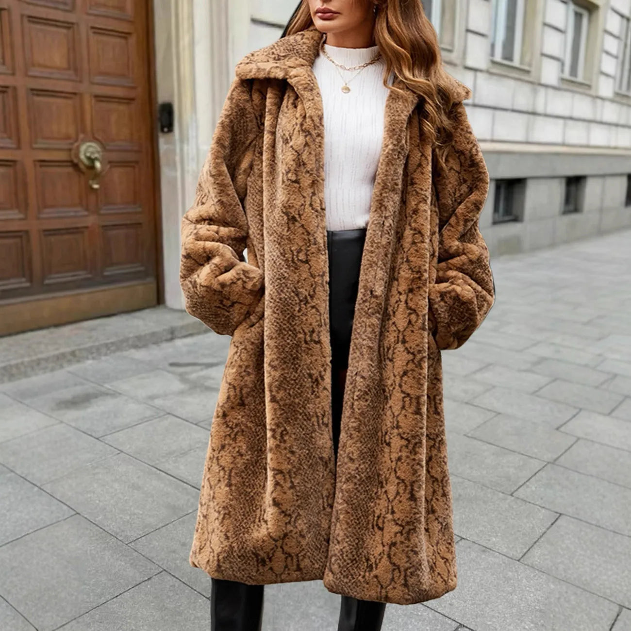 Women's long faux fur leopard print coat with regular sleeves on a hanger.