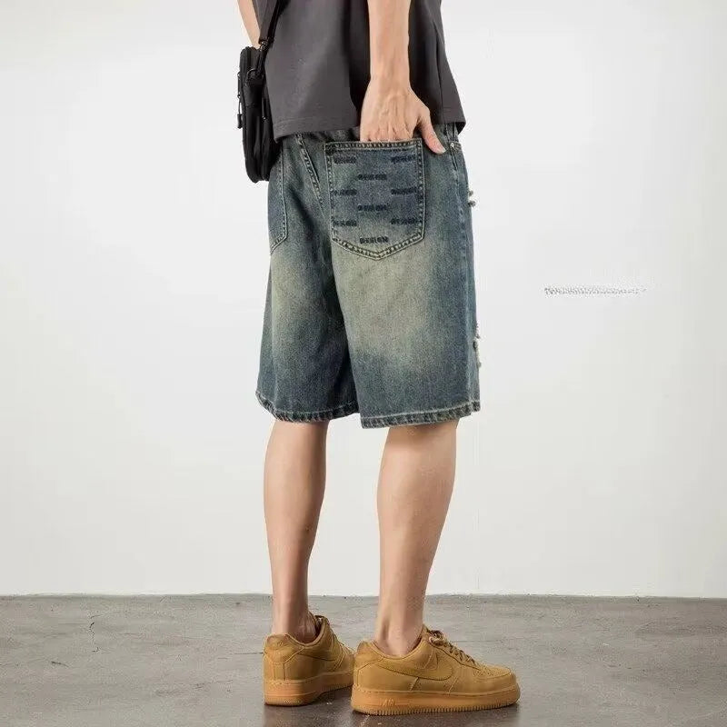 Blue retro loose hole men's denim shorts with a straight cut, shown on a model.