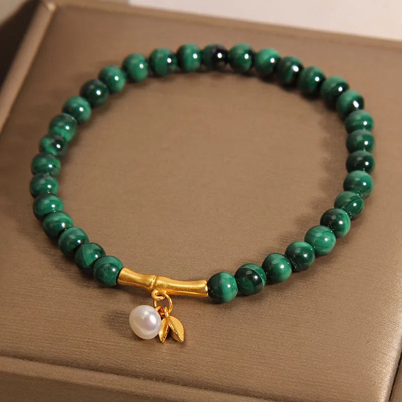 Women's white crystal bracelet with bamboo charm on adjustable metallic chain showing length between 20-24cm