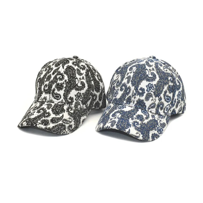 Blue polyester baseball cap with a white paisley pattern print and a dome crown.