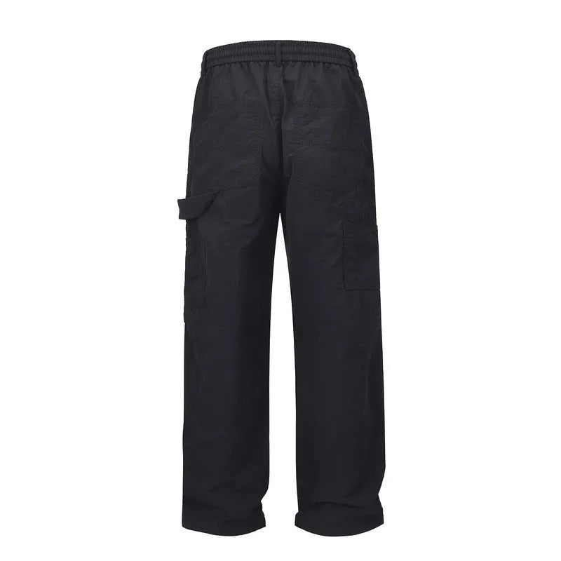 Black baggy paratrooper pants with an elastic waistband on a neutral background.