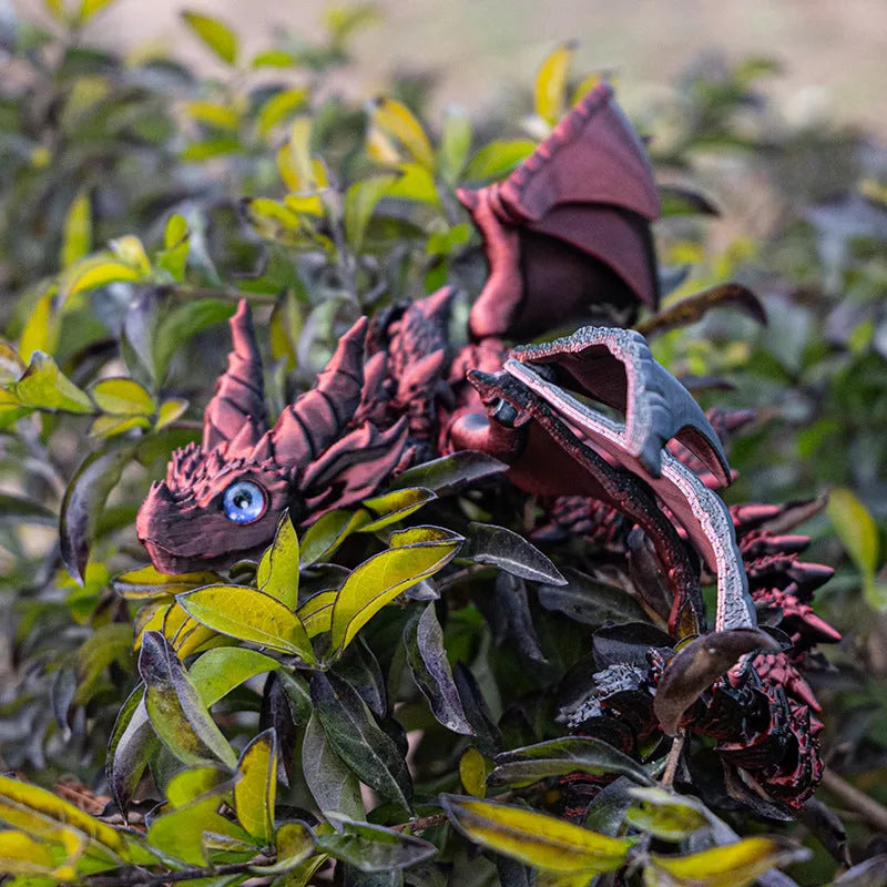 Red and gold printed dragon wings decorative toy made of PLA plastic.