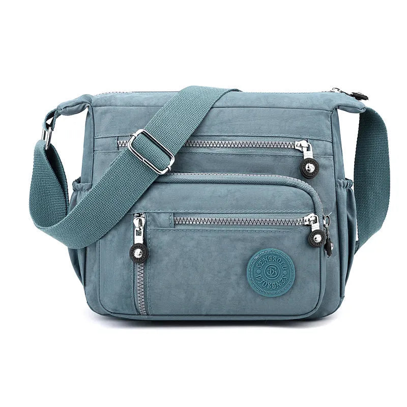 Grey soft nylon messenger bag with single adjustable shoulder strap showing square vertical shape