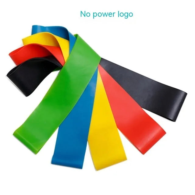 Five colour-coded yoga tension straps for resistance training laid flat showing green, blue, yellow, red, and black options
