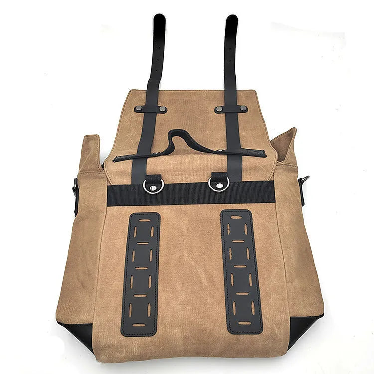 Black waterproof canvas motorcycle side pannier bag with cowhide detailing showing mounted position on bike