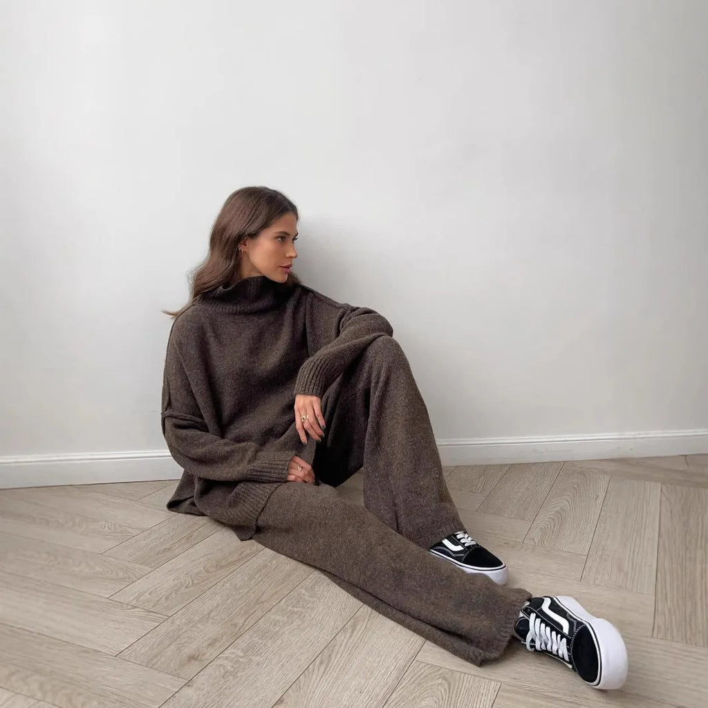 Women's dark grey acrylic jumper suit with side slits on the top and matching trousers.