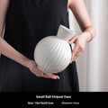 White ceramic ball striped vase on table with American country styling