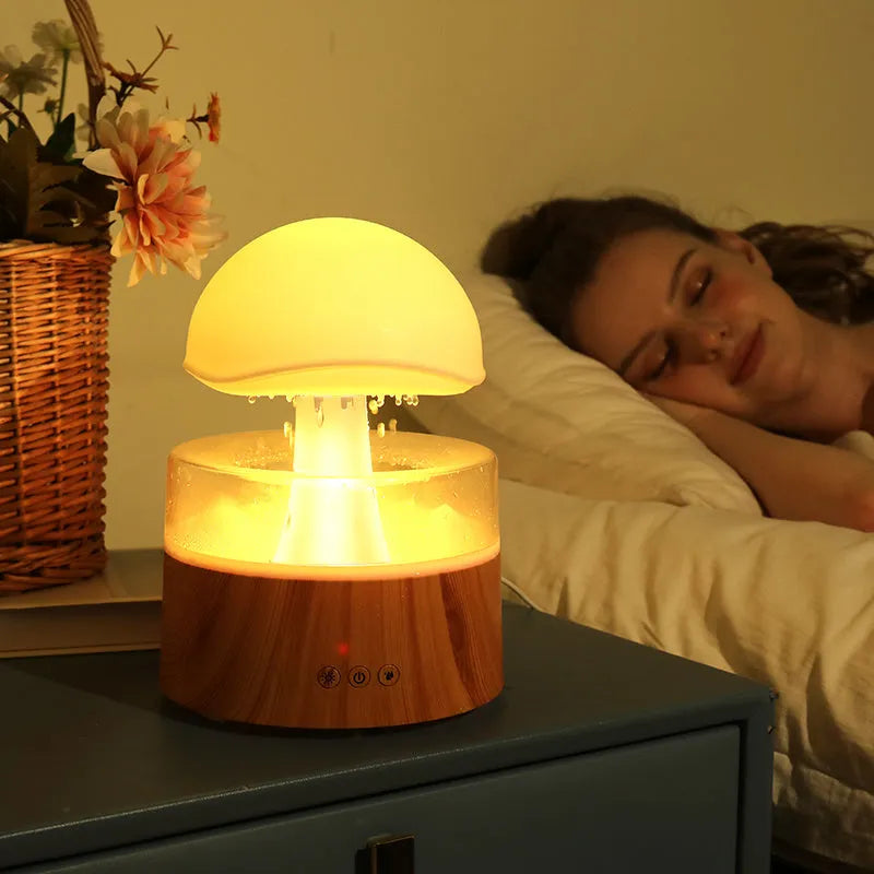 White cloud-shaped humidifier emitting mist with multi-coloured lighting and remote control
