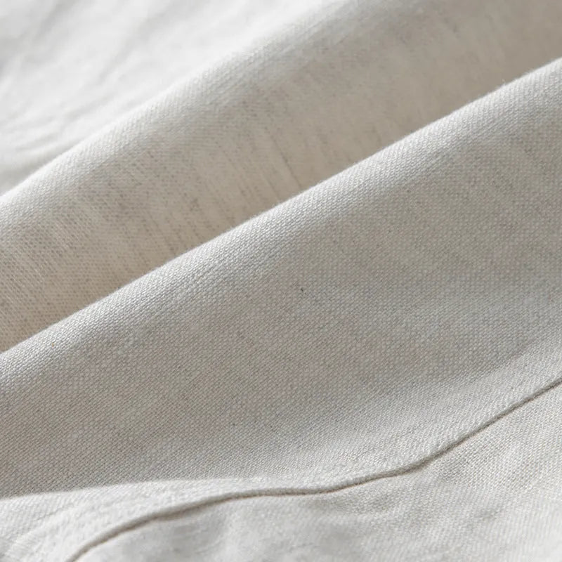 Men's casual linen suit jacket in a solid colour on a hanger, showing long sleeves and loose fit.