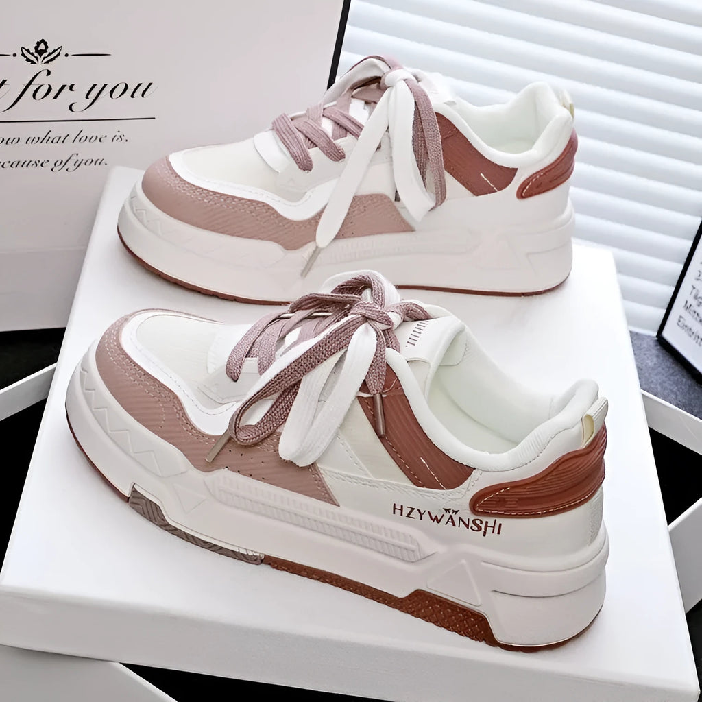 Children's beige lace-up board shoes with thick rubber sole and cross shoulder strap detail.