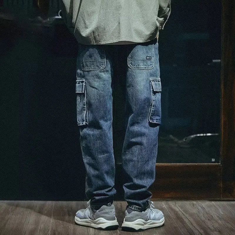 Blue loose straight-leg men's retro jeans with a zip fly on a plain background.