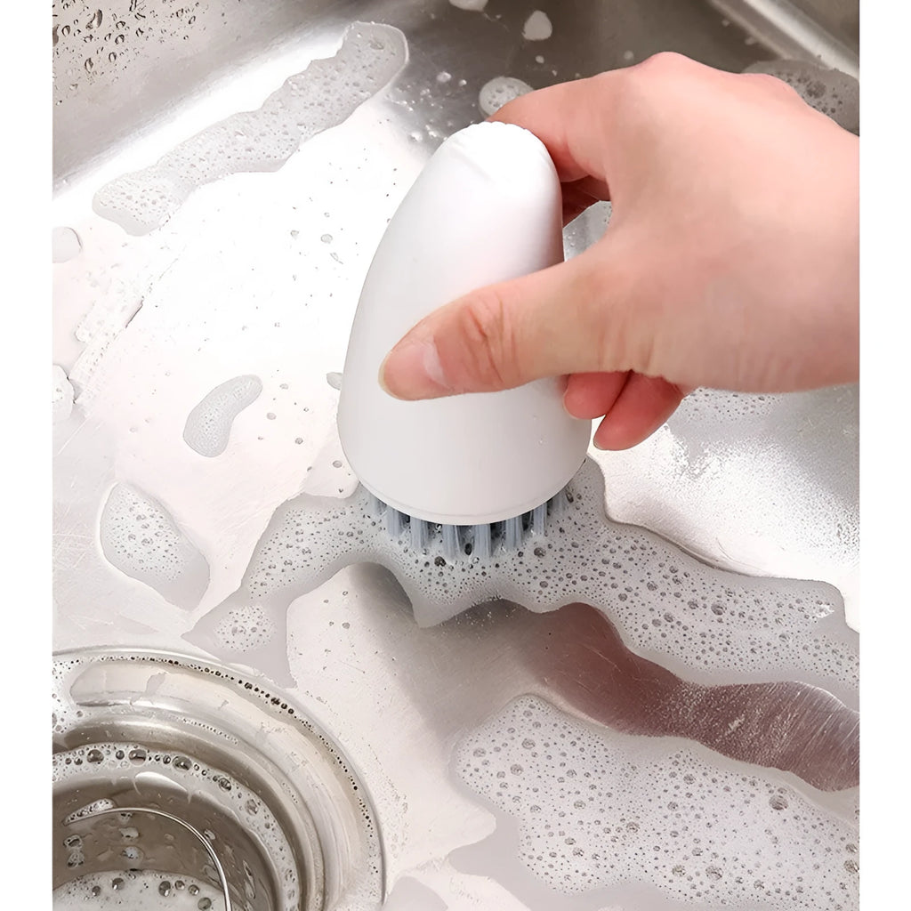 Carrot-shaped nylon kitchen cleaning brush on a white background, shown in orange and white colour options.