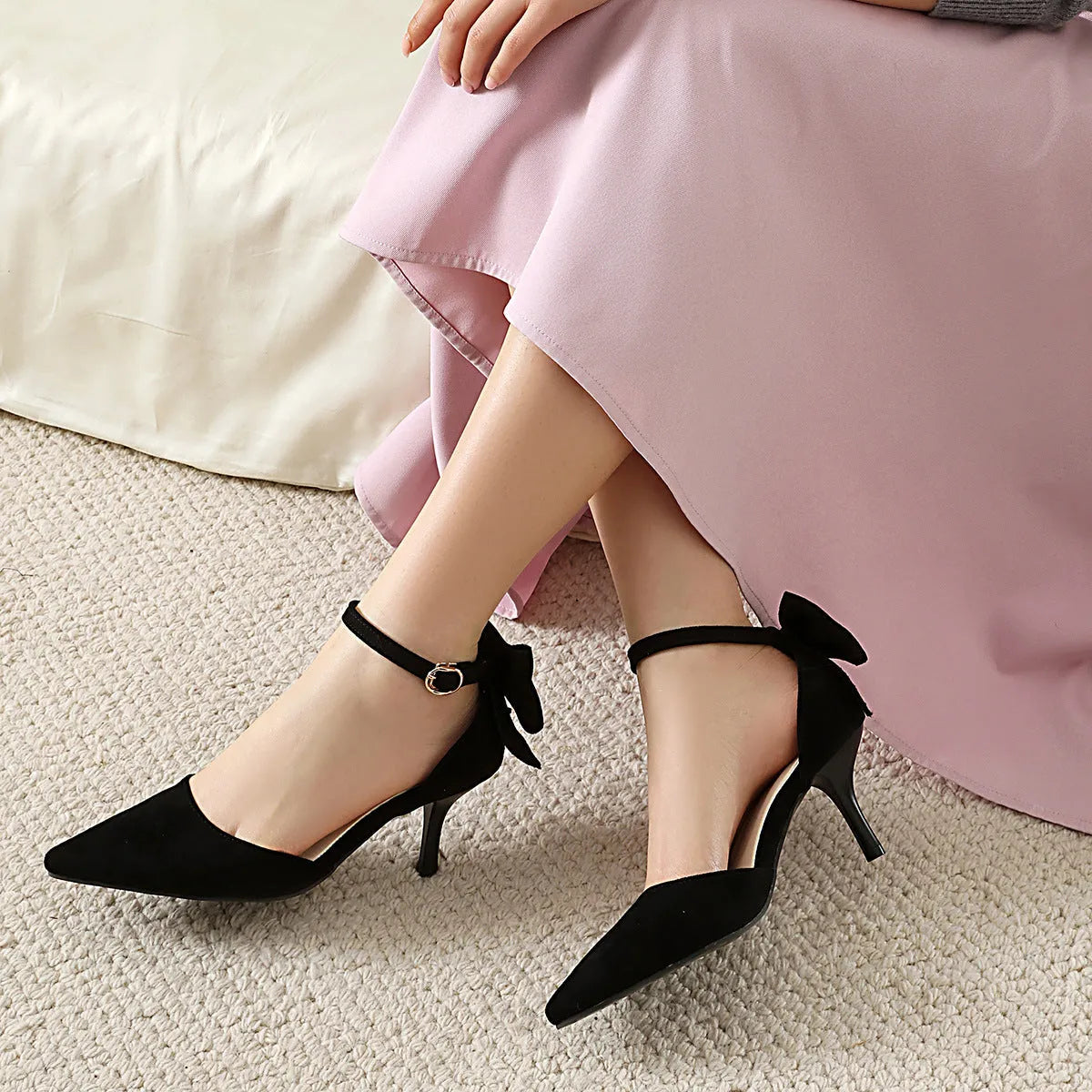 Women's suede stiletto heels with pointed toes and decorative bowknot detail in black colour
