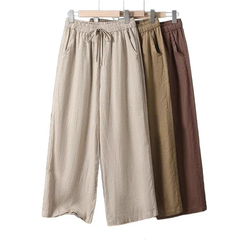 Women's straight-leg casual trousers in apricot colour with an elastic and drawstring waistband.