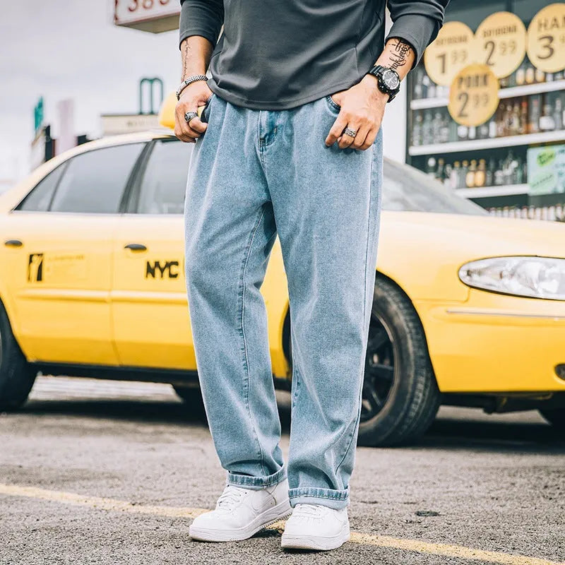 Men's loose straight-leg casual jeans in dark blue cotton fabric with a zip fly.