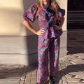 Women's floral print trousers suit set with tie-neck top and puff sleeves