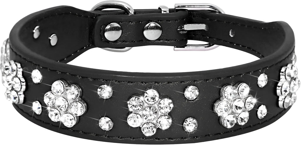 Close-up of a black PU leather dog collar with silver rhinestone flowers and studs, showing the metal D-ring.