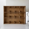 Solid wood square storage rack with multiple grid compartments in a birch wood meridian colour.