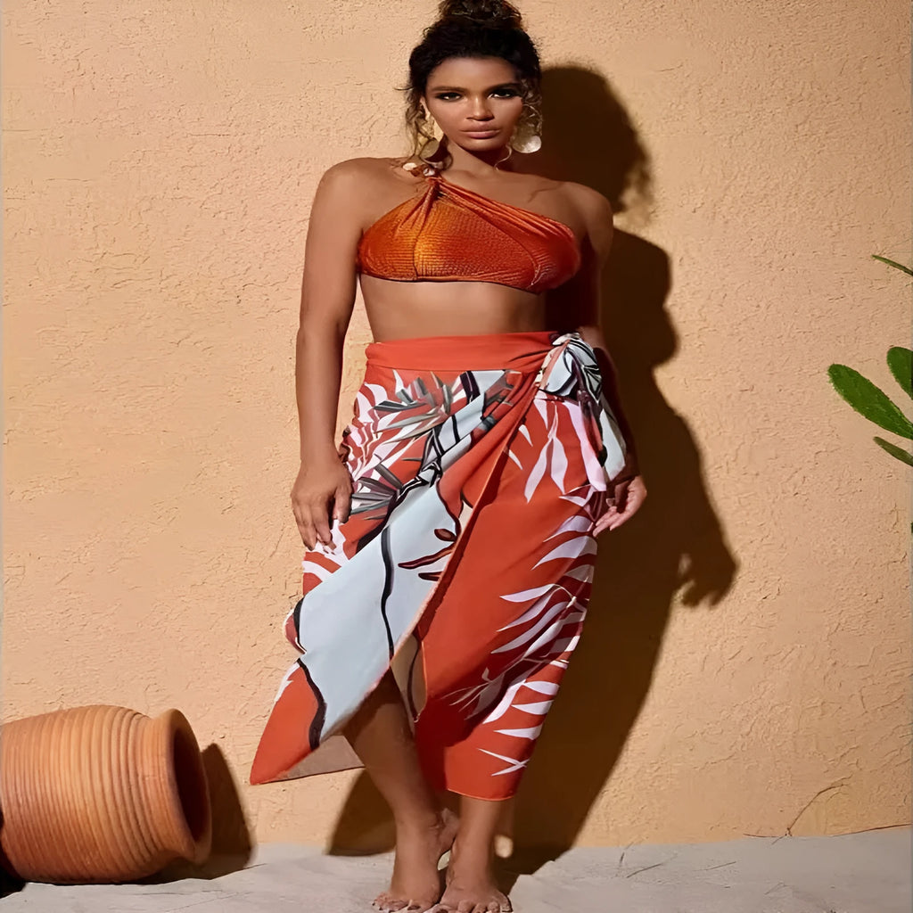 Women's brown push up bikini with high waist briefs and matching chiffon dress cover-up laid flat.
