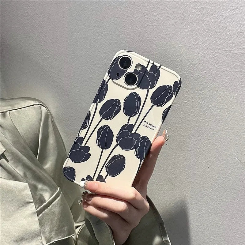 Black silicone iPhone case with a tulip floral pattern on the back.