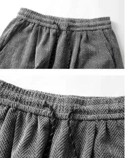 Man's straight-leg fleece-lined trousers in black with an elastic waistband, showing hollow-out fabric texture.
