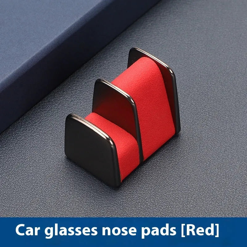 Zinc alloy and leather car dashboard clip for holding glasses, shown in grey.