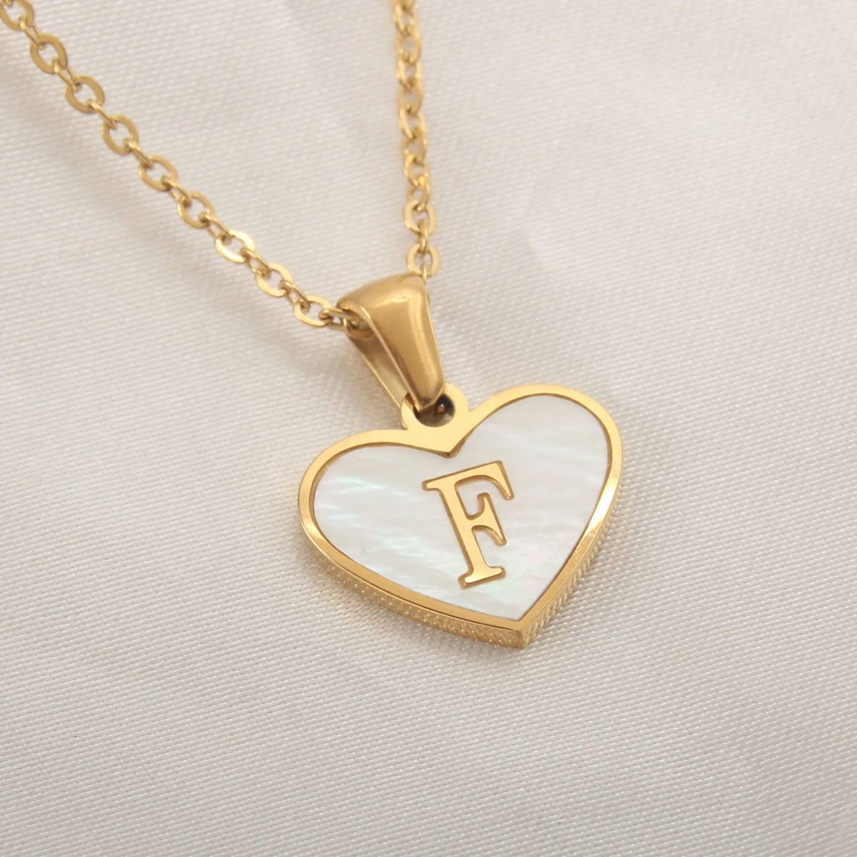 Gold plated initial necklace with white shell heart pendant and adjustable chain