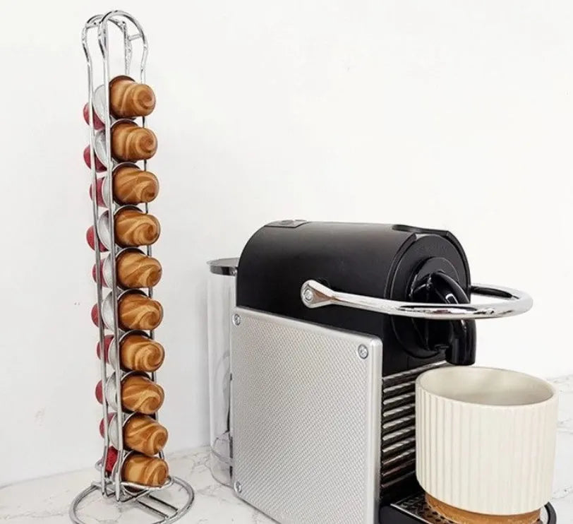 Black wrought iron coffee capsule storage rack holding pods on shelves