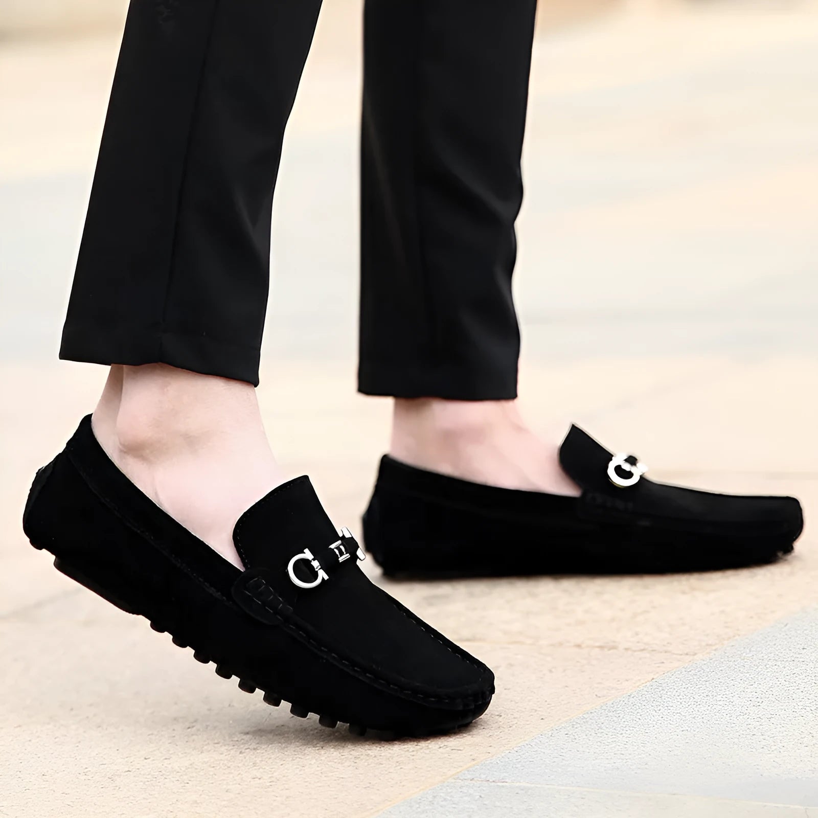Men's black slip-on cowhide leather shoes with square toe and visible stitching on a rubber sole.