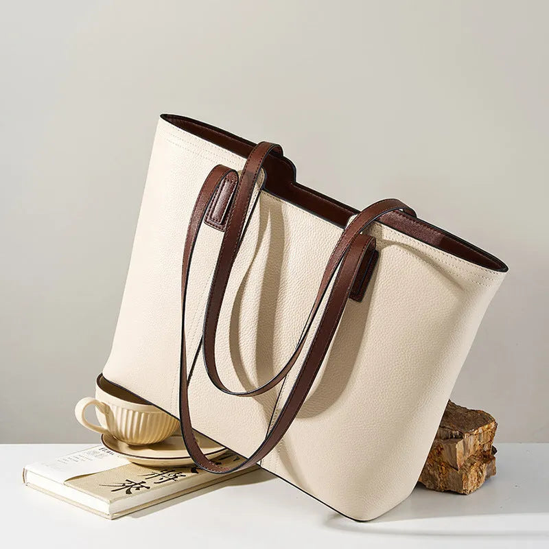 Women's black genuine leather commuter bag with crossbody strap and internal organiser pockets