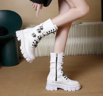 Women's black mid-calf knight boots with a large metal buckle and side zip fastening