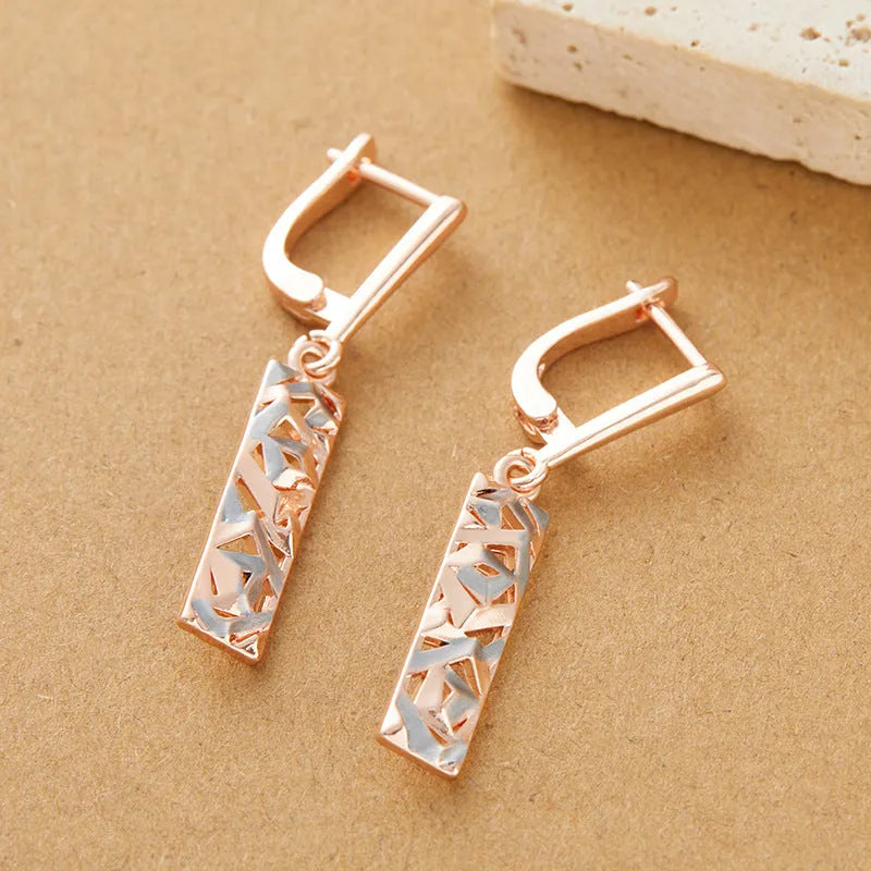 Rectangular two-tone hollow geometric alloy stud earrings for women with electroplated finish.