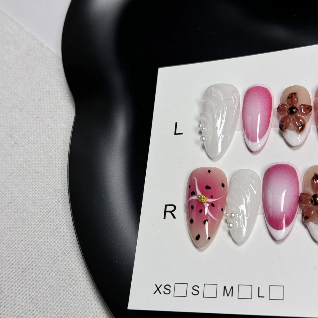 Hand-painted three-dimensional carved nail beauty patches in candy colours on an almond-shaped nail.