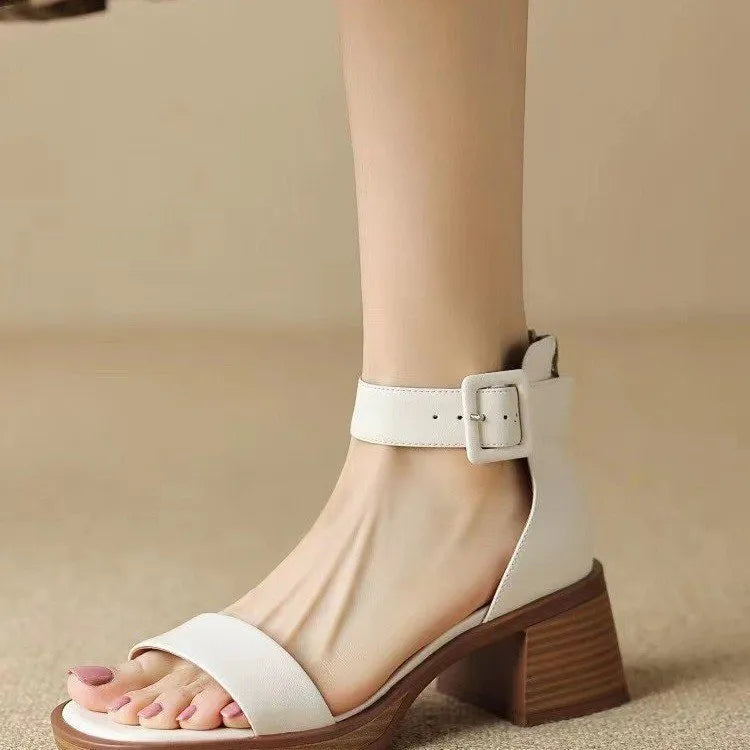 Women's white retro ankle-strap platform high heels with a round toe.