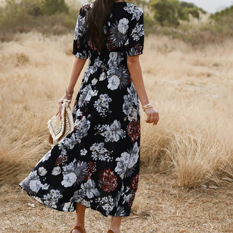 Yellow floral print women's dress with V-neck, short sleeves, elastic high waist, and flowing mid-length skirt.
