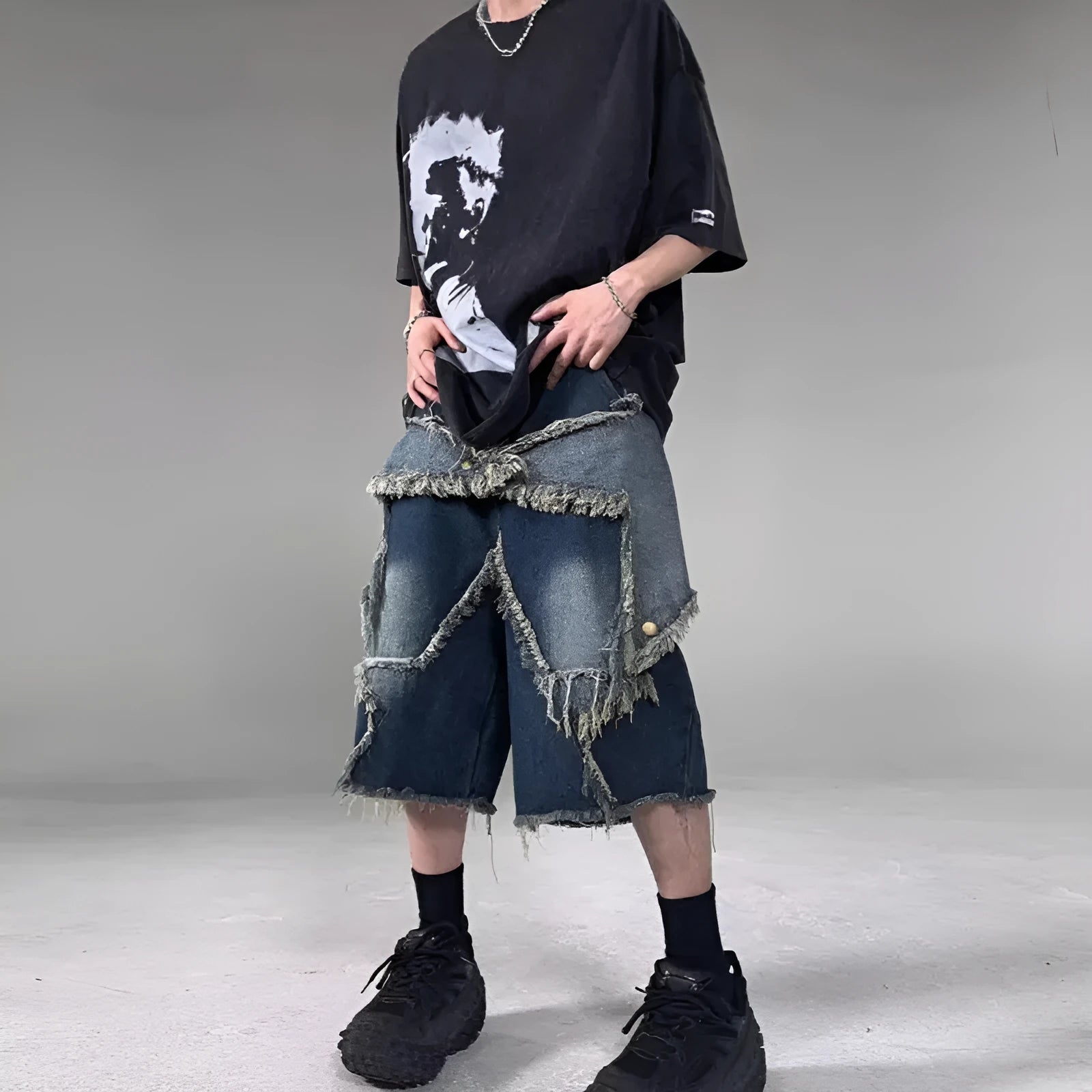 Blue loose-fit men's denim shorts with a frayed hem and a large retro star design on the leg.