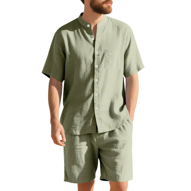 Men's light blue linen two-piece suit with short-sleeved henry collar shirt jacket and shorts on a hanger.