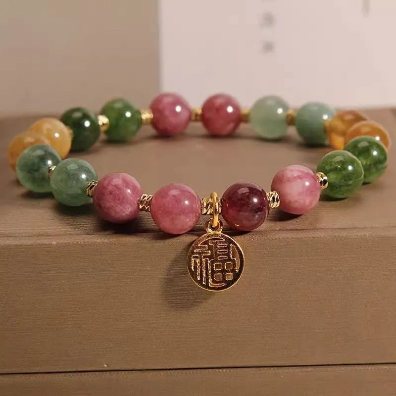 Natural colour tourmaline bracelet with floral and fu character designs on geometric casual jewellery