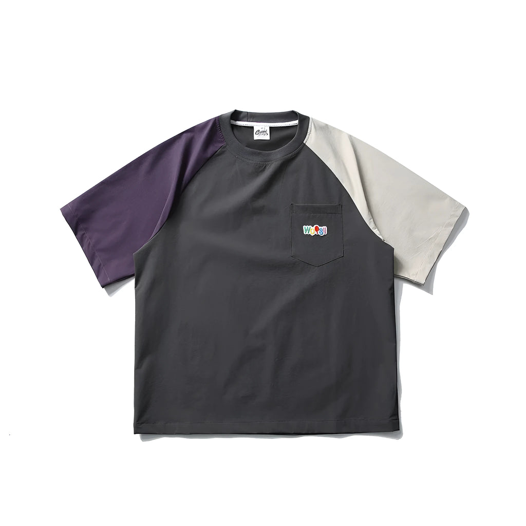 Dark grey loose fit quick-dry t-shirt with contrast raglan sleeves on a hanger.