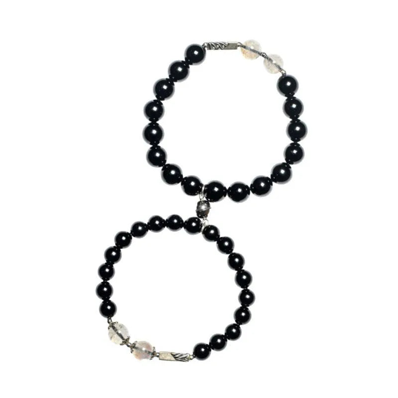 Obsidian Buddha beads couple bracelet set showing 8mm women's and 10mm men's sizing differences
