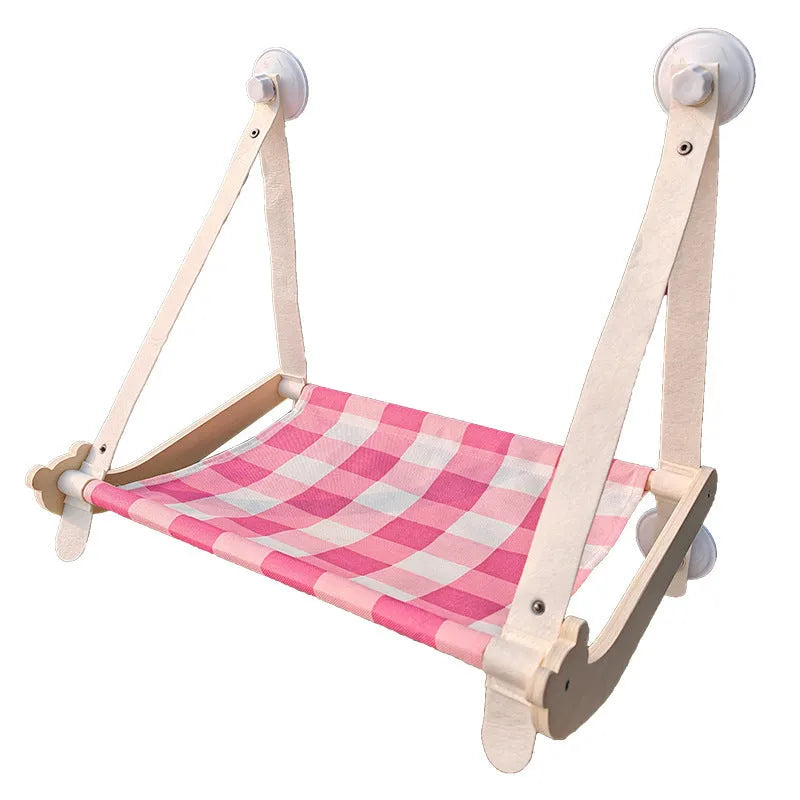 Wooden frame cat window hammock bed with linen fabric attached by suction cups to a window.