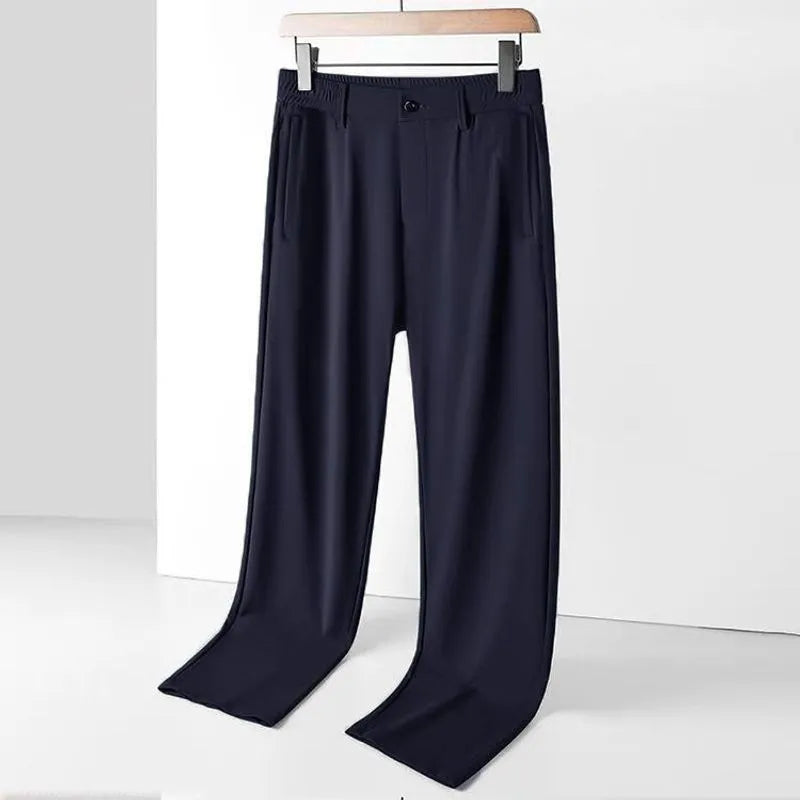 Man wearing black ice silk loose straight-leg trousers with a high elasticity open waist.