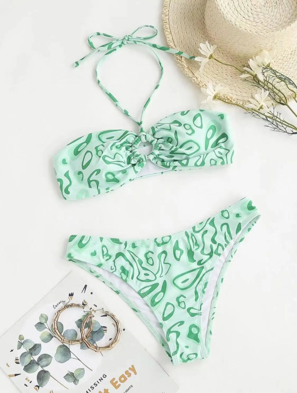 Green floral bandeau bikini with split design and backless styling on swimwear model