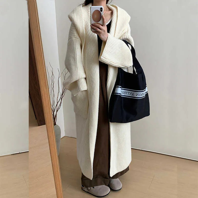 Loose hooded cardigan coat with raglan sleeves in acrylic fabric showing extended length