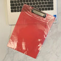 Transparent A4 clipboard with metal flat clip holding paper, shown in blue colour option.