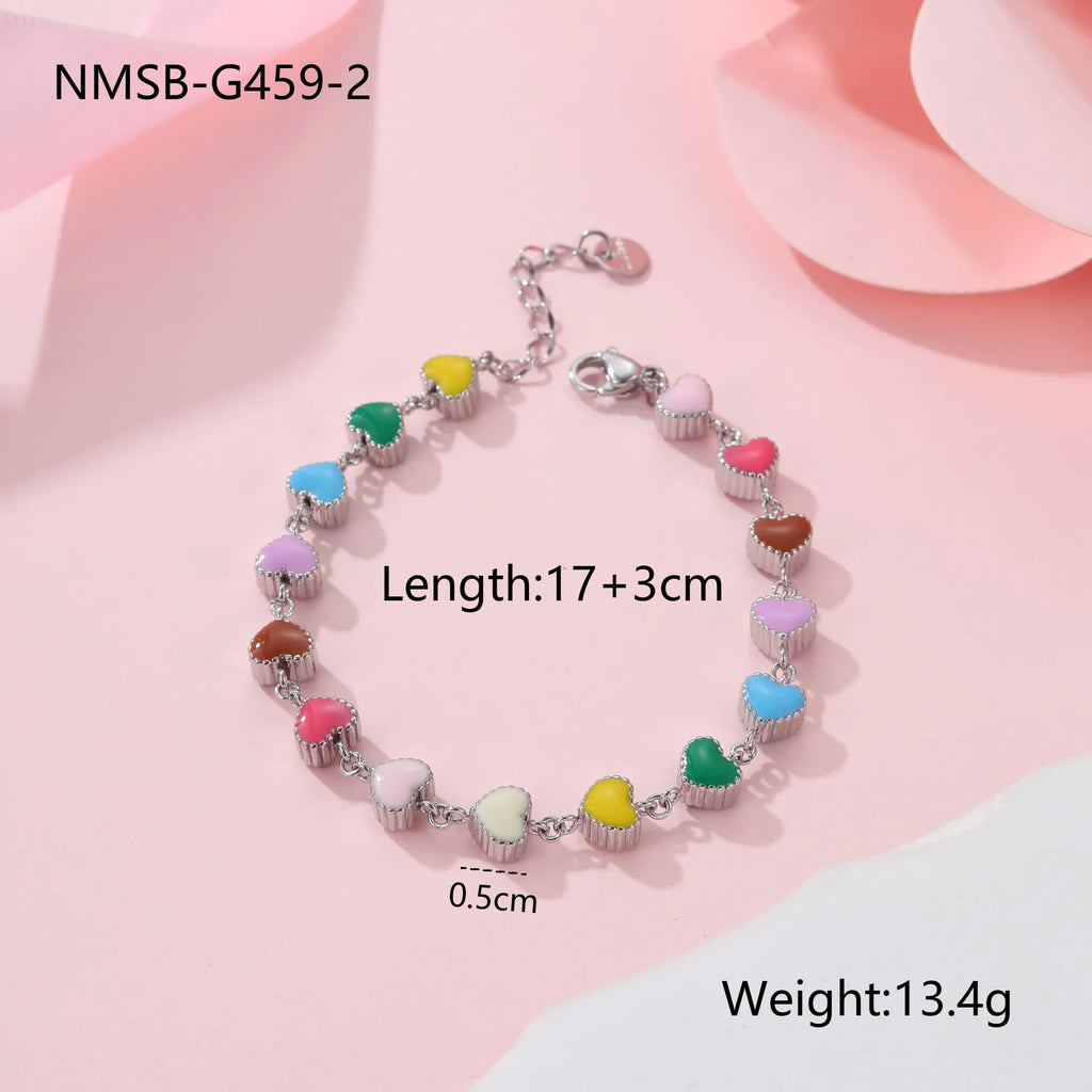 Women's stainless steel bracelet with love heart pendant featuring colourful oil finish in gold or steel colour