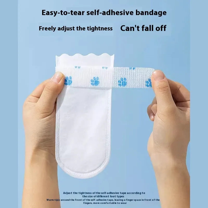 White disposable waterproof shoe covers for dogs with non-slip soles in S and M sizes